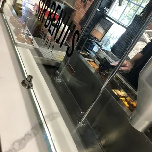 One employee making the donuts and ringing up customers