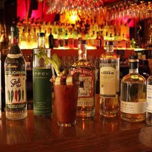 a row of liquor bottles on a bar