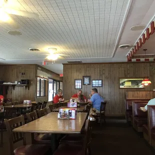people sitting at tables in a restaurant