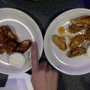 two plates of chicken wings and dip