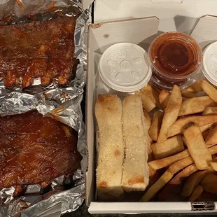Slab of ribs comes with coleslaw, fries, and bread sticks. Requested extra sauce.