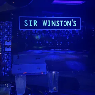 a bar with a neon sign