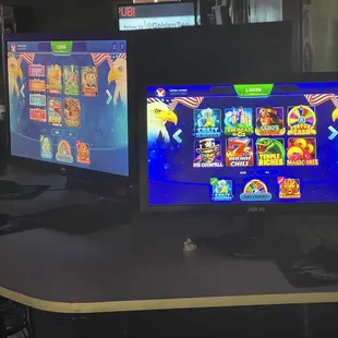 two computer monitors on a desk