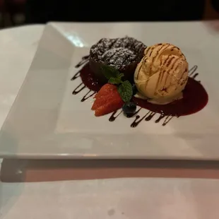 Tortino al Cioccolato: Warm mini chocolate cake, vanilla gelato &amp; mixed berries sauce.