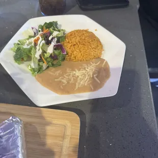 Molcajete Ranchero with rice, beans and a salad.