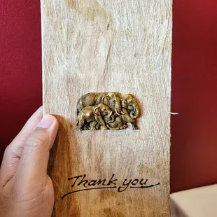 a hand holding a thank card