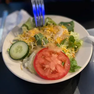 a plate of salad and a fork