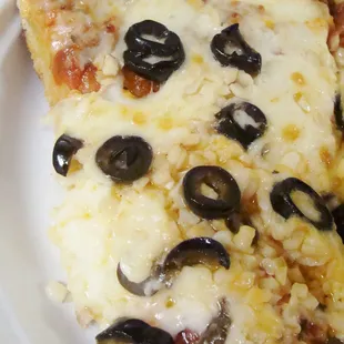pizza with olives, garlic, and extra cheese - look at that mound of fresh garlic!
