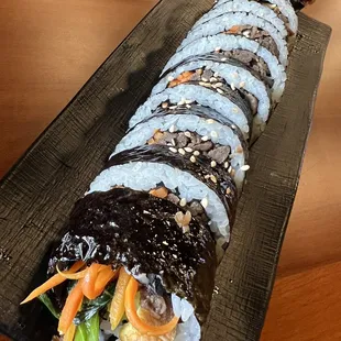 a sushi roll on a black plate
