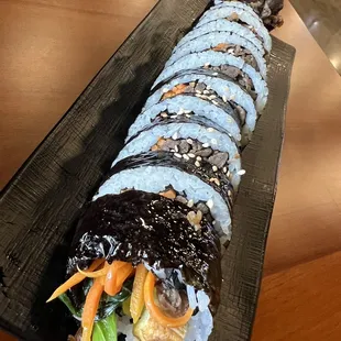 a sushi roll on a black plate