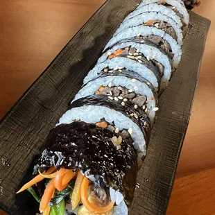 a sushi roll on a black plate