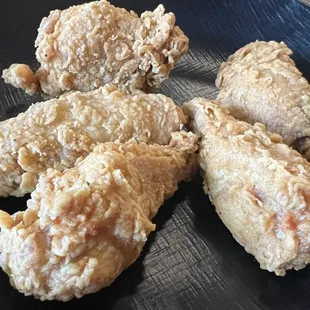 fried chicken on a black plate