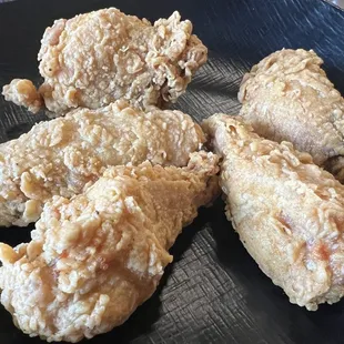 fried chicken on a black plate