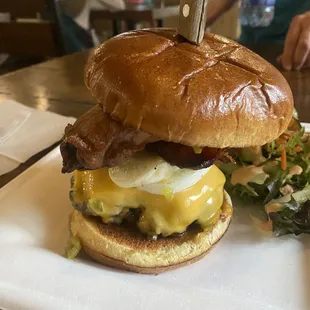 a burger and a salad on a plate