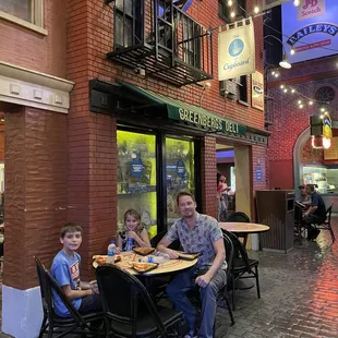 a man and two children sitting at a table