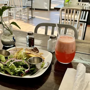 Steak jibarito (plantain sandwich) with strawberry lemonade and side salad served with hot sauce and passion fruit dressing