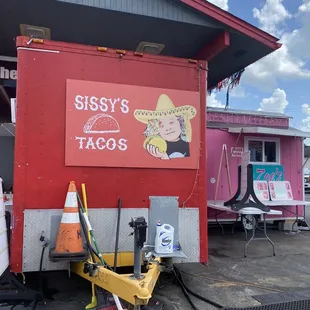 a taco truck parked in front of a building