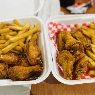 two trays of chicken wings and french fries