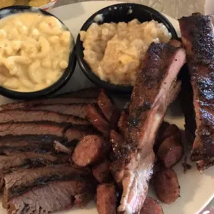 Our generous 3 Meat Plate with Juicy Ribs, Brisket and Sausage with Dem Tators and Homemade Mac-n-Cheese.