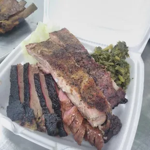 ribs and vegetables in a styrofoam container