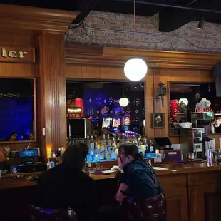 a group of people sitting at a bar