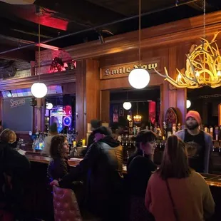 a large group of people sitting at a bar