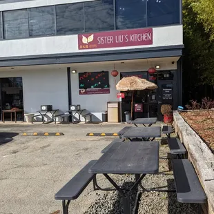 Outside. Storefront. Patio dining and order pick-up boxes. Located just off I-40 exit 270.