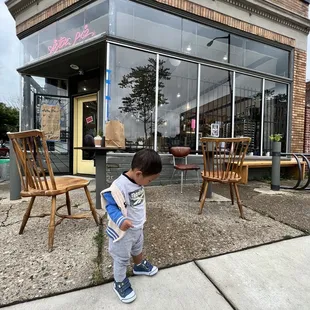 My son enjoying the outdoor sitting area while eating his strawberry scone.