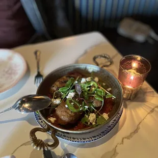 a bowl of soup with meat and vegetables