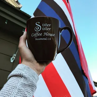 a person holding a coffee cup