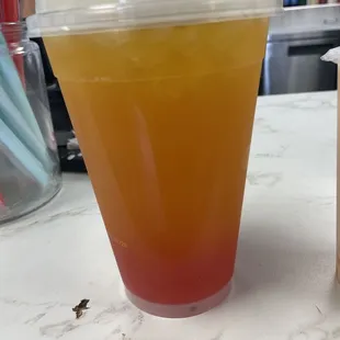 Passionfruit milk tea with strawberry pearls