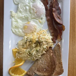 Eggs, wheat toast, bacon and cheesy hashbrowns
