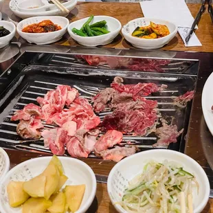 a variety of meats on a grill