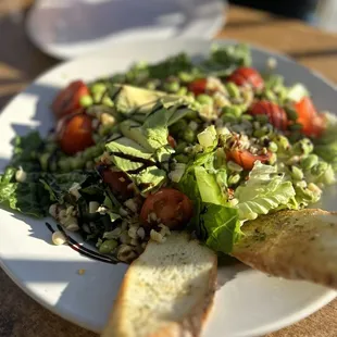 a plate of salad and bread