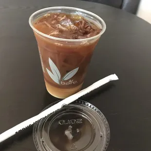  glass of iced coffee and a straw