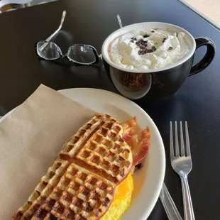  waffle sandwich and a cup of coffee