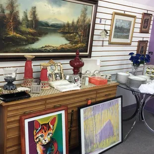 Love how the art is displayed both on walls and enhancing the display of other items. Good art prices.