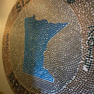 a circular artwork made of beer bottle caps