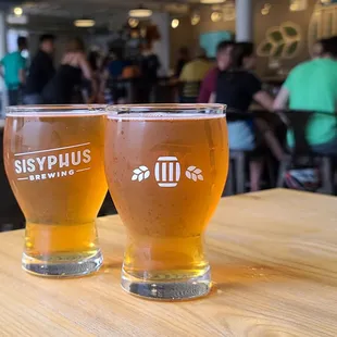 two glasses of beer on a table