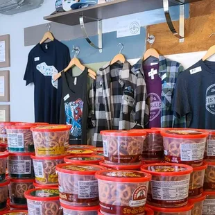 a display of shirts and cups