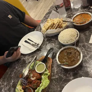 tandoori chicken, goat curry, butter chicken, garlic naan and rice