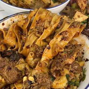 **Ma Hu Beef Noodles**  Hand-pulled noodles with tender braised beef and a blend of century-old traditional spices, garnished with cilantro