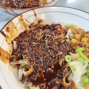 **Zha Jiang Noodles**  
   *Hand-pulled noodles with onions, mushrooms, and minced pork, seasoned with house-made Zha Jiang sauce.*