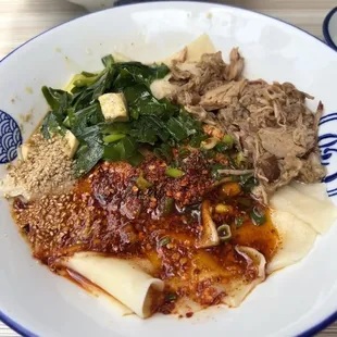 **Braised Pork Noodles** 
   *Hand-pulled noodles with slow-braised pork cooked for 10 hours, served with red and green bell peppers.*