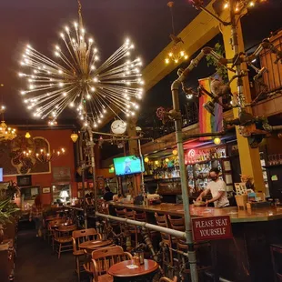 a bar with a chandelier in the background