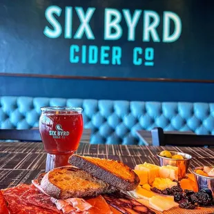 a platter of food and a glass of beer