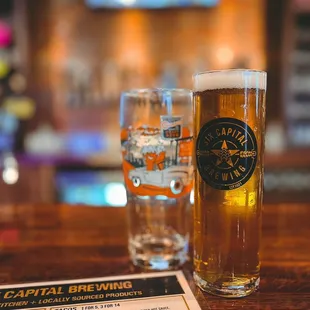 two glasses of beer and a menu