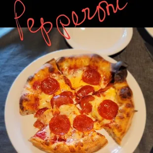 a pepperoni pizza on a plate