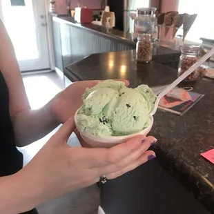 a woman holding a bowl of ice cream