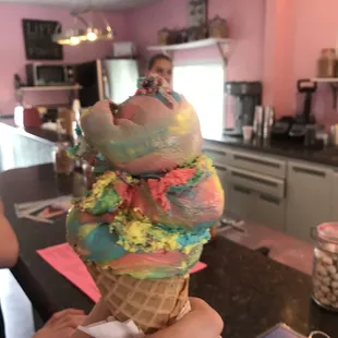 a person holding an ice cream cone